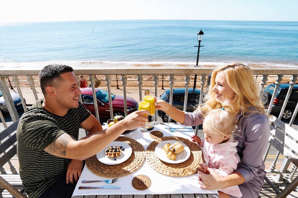 Couple enjoying a romantic breakfast on the balcony