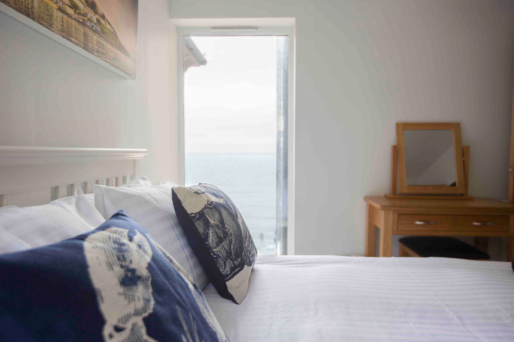 Photo of the master bedroom window on the left side of the room which faces the sea.
