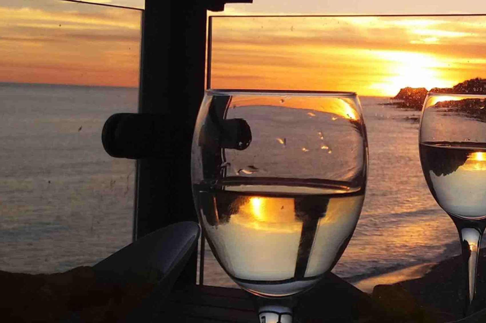 Beach Haven two wine glasses positioned in the sunset overlooking Ventnor Bay