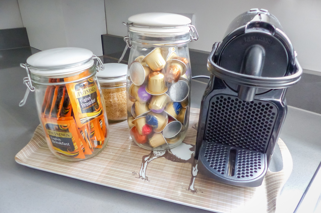 Coffee Machine in the Kitchen with pods in a jar. Twinnings Tea bags and brown sugar.