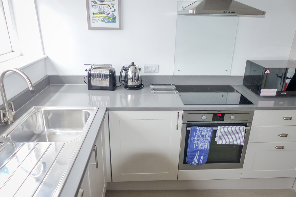 Franks Kitchen Area, Sink with mixer tap, toaster, kettle, electric oven and hob with microwave pictured.